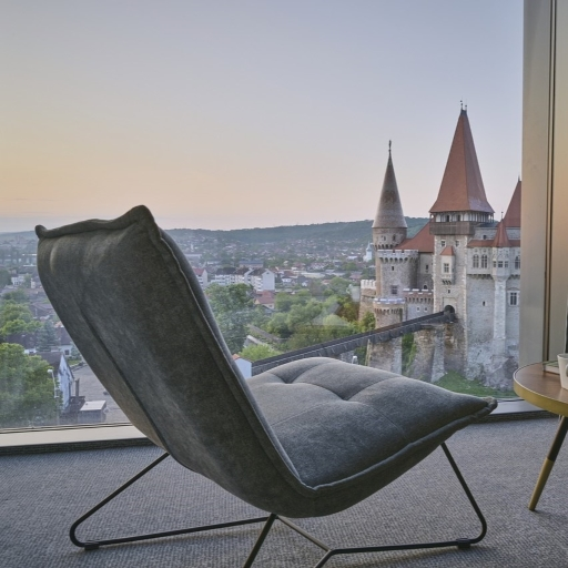 Chair and table by a castle-facing window before editing