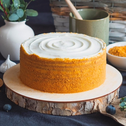 Round orange-frosted cake before editing